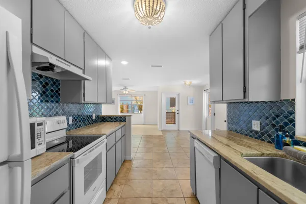 a kitchen with a sink stove and cabinets