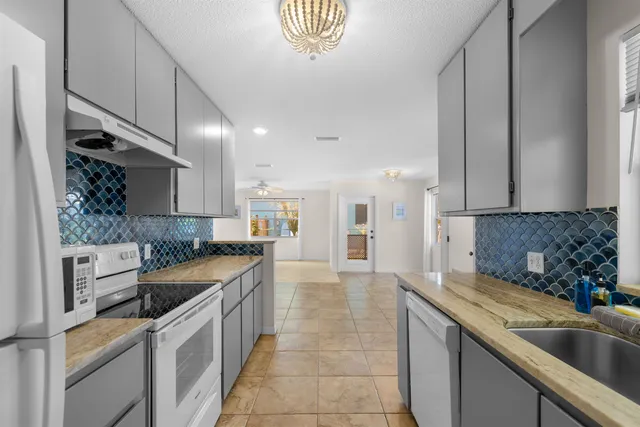 a kitchen with a sink stove and cabinets
