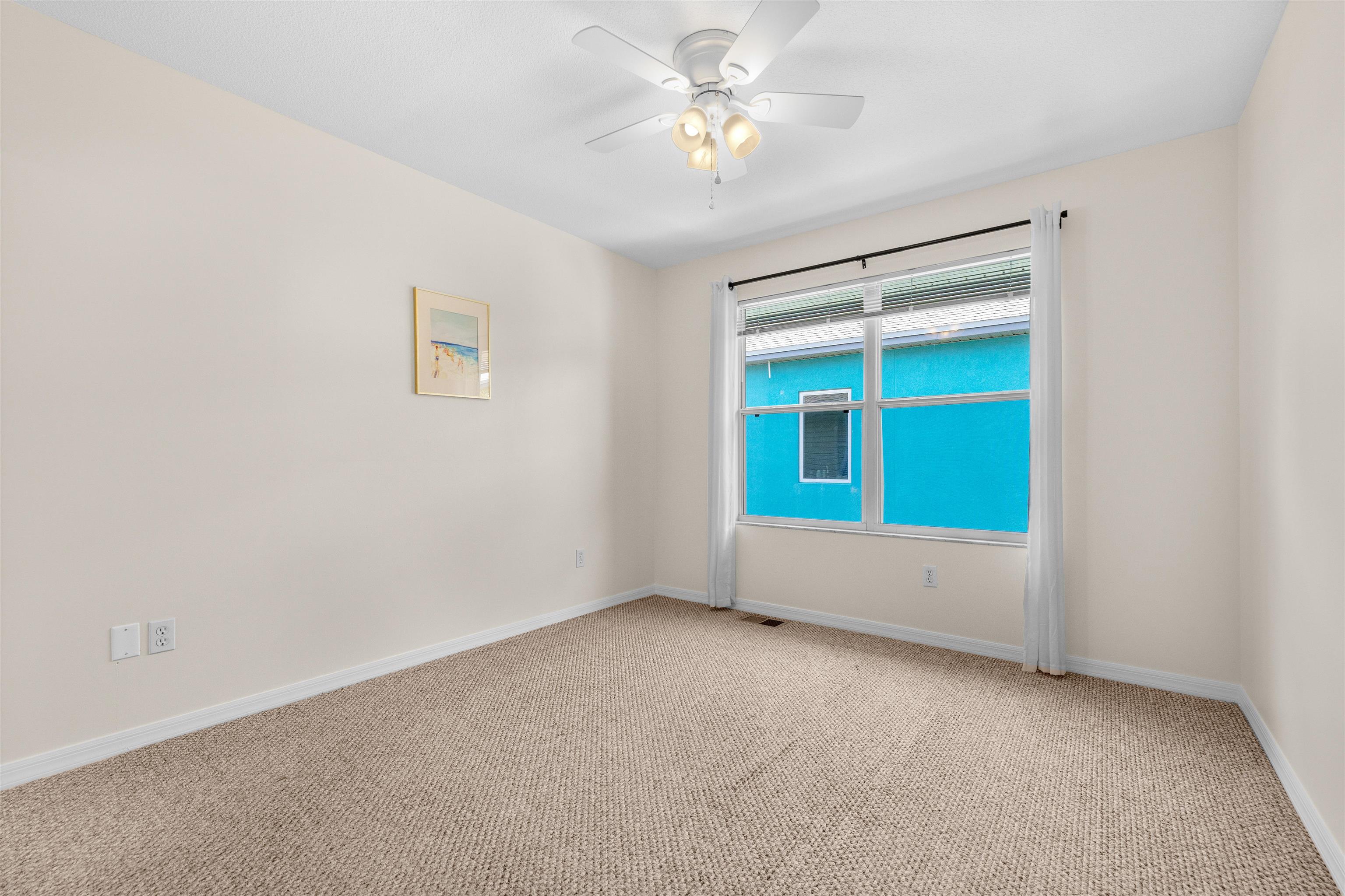 109 B Street, Unit B St. Augustine Beach, FL 32080 - Photo 18 of 30 an empty room with a window and a ceiling fan