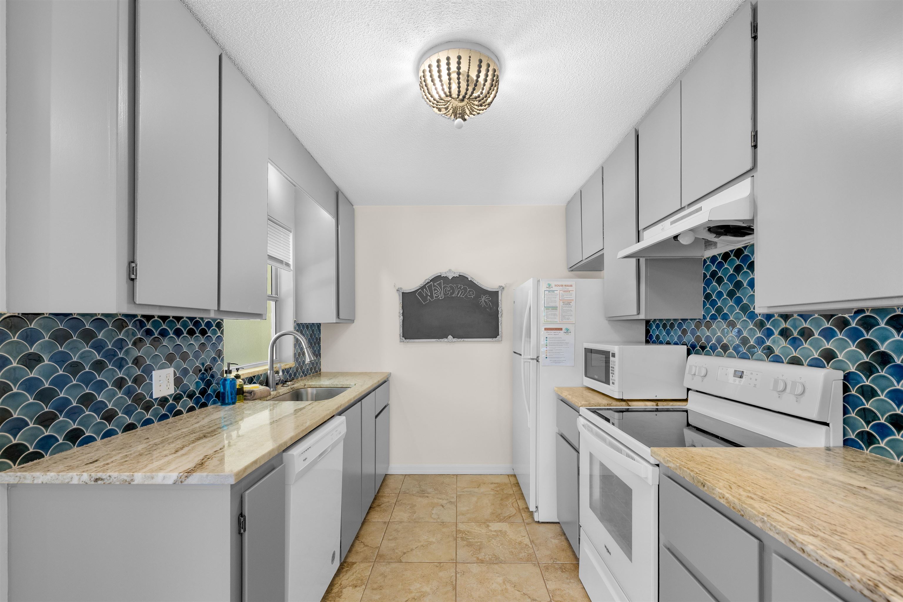 109 B Street, Unit B St. Augustine Beach, FL 32080 - Photo 2 of 30 a kitchen with a sink stove and cabinets