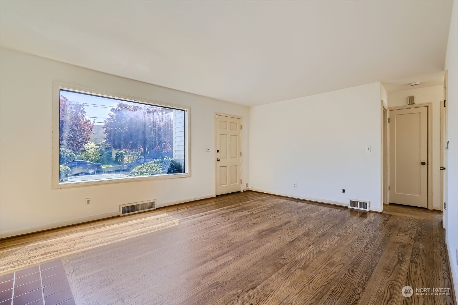 730 North 67th Street Seattle, WA 98103 - Photo 25 of 37 an empty room with wooden floor and window