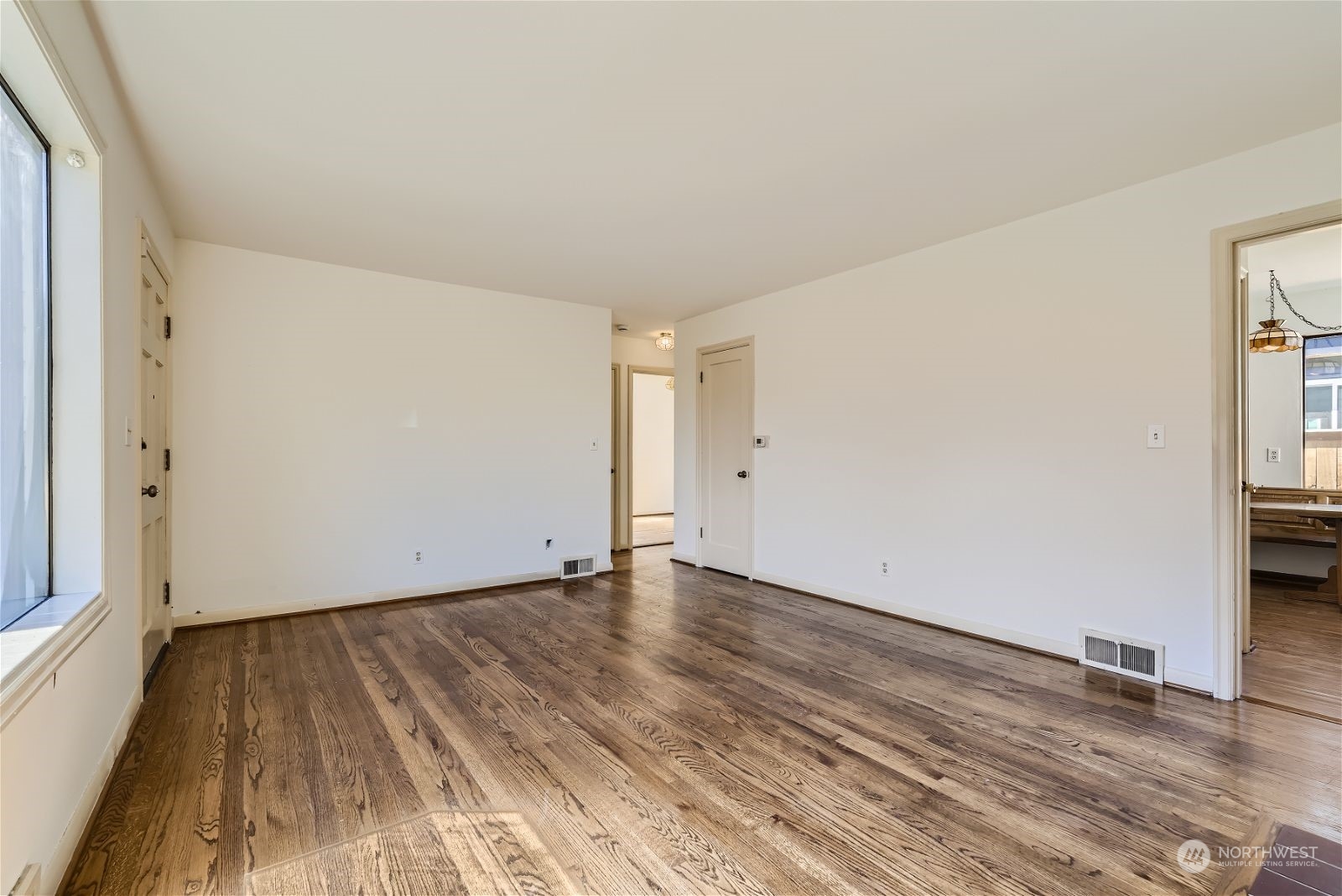 730 North 67th Street Seattle, WA 98103 - Photo 26 of 37 a view of an empty room with wooden floor and a window