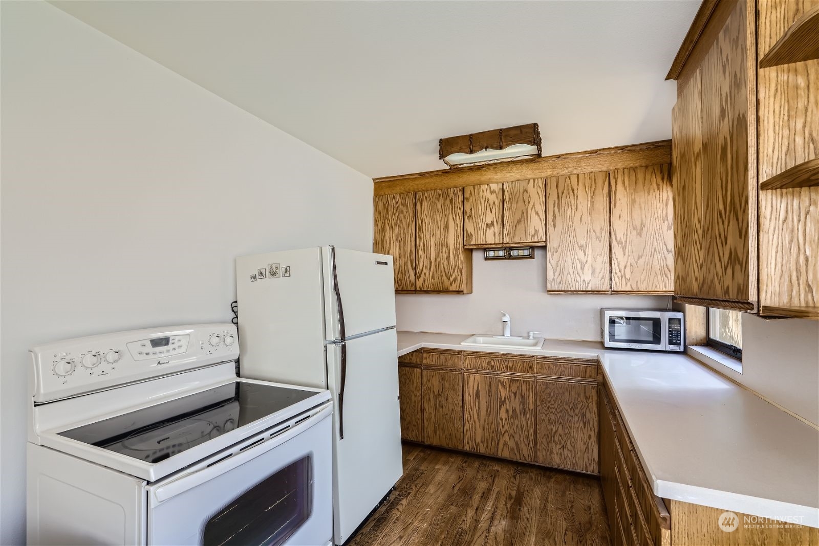 730 North 67th Street Seattle, WA 98103 - Photo 30 of 37 a kitchen with wooden cabinets and refrigerator