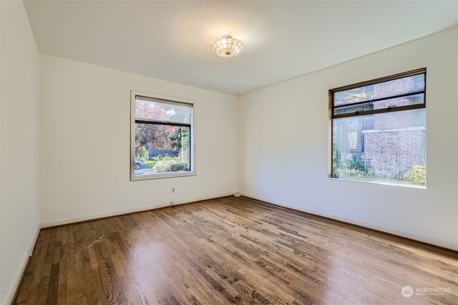 730 North 67th Street Seattle, WA 98103 - Photo 33 of 37 a view of an empty room with wooden floor and a window