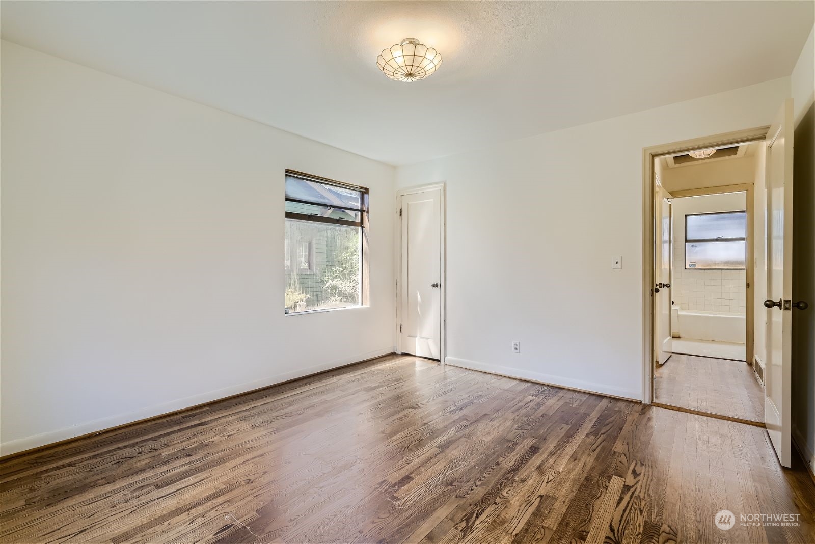 730 North 67th Street Seattle, WA 98103 - Photo 34 of 37 an empty room with wooden floor and a window