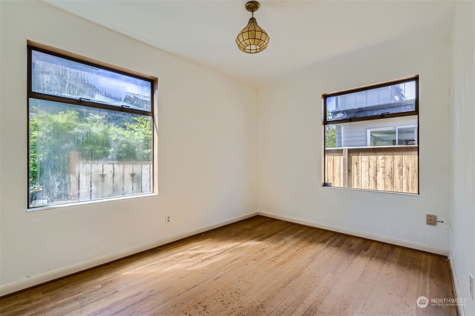 730 North 67th Street Seattle, WA 98103 - Photo 36 of 37 a view of an empty room with wooden floor and a window