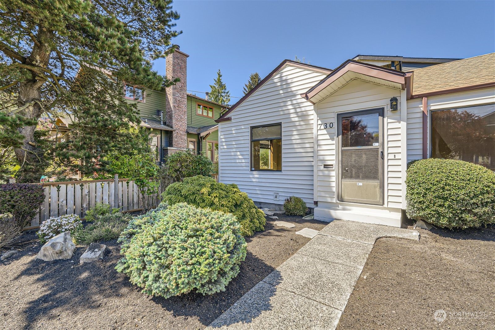730 North 67th Street Seattle, WA 98103 - Photo 4 of 37 a view of a house with a small yard and plants