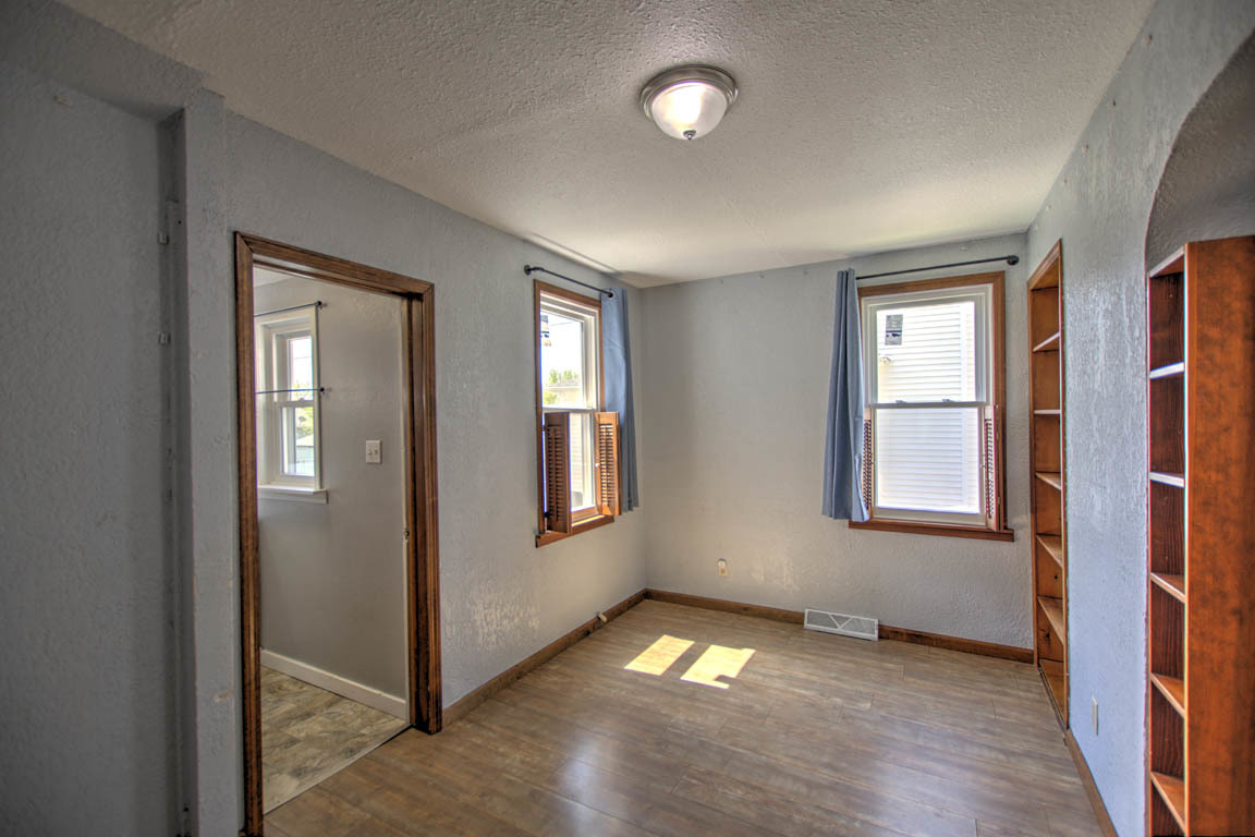 204 West South Street Clinton, IL 61727 - Photo 11 of 23 an empty room with wooden floor and windows