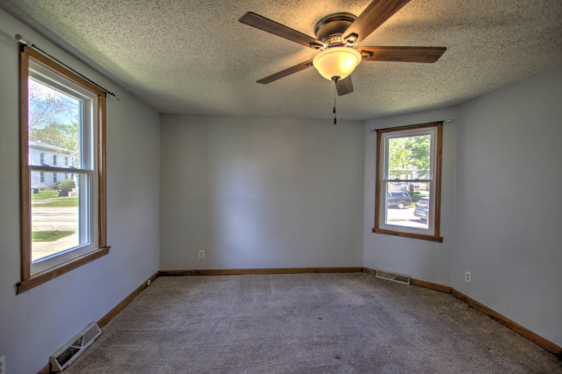 204 West South Street Clinton, IL 61727 - Photo 12 of 23 an empty room with a window and a fan