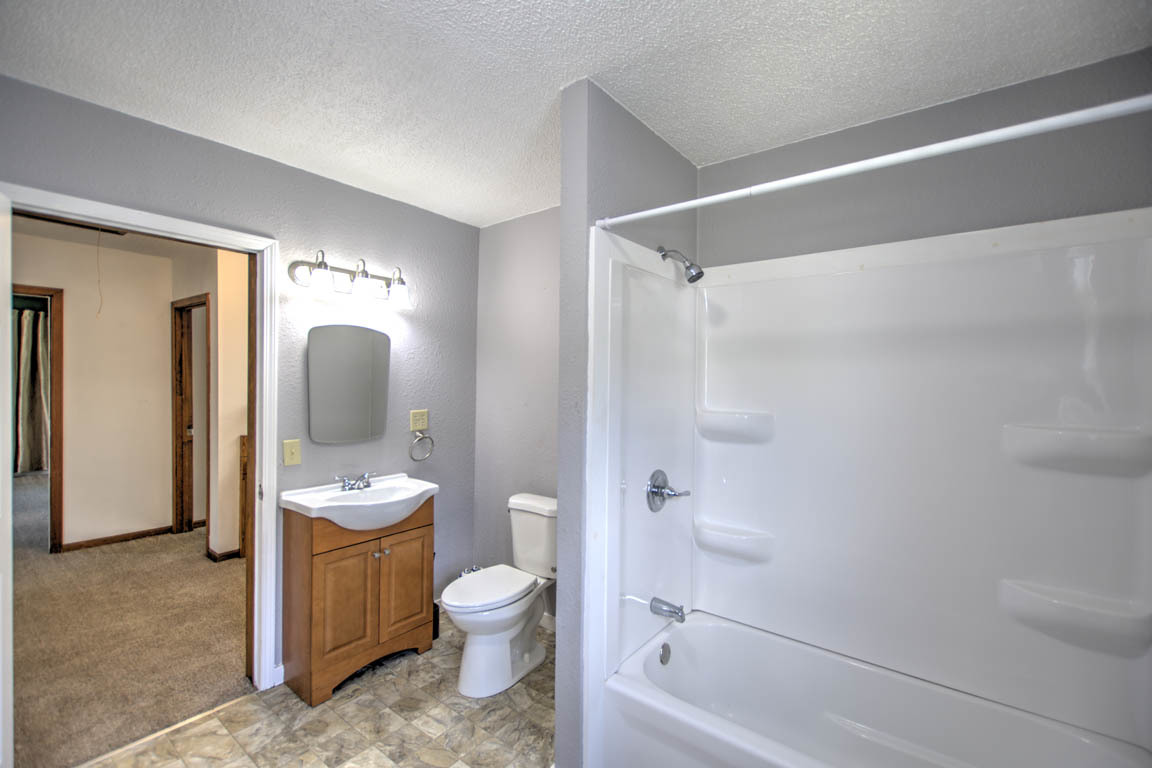 204 West South Street Clinton, IL 61727 - Photo 15 of 23 a bathroom with a toilet a sink and a shower