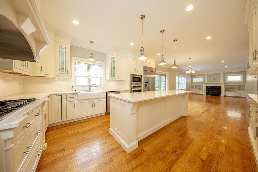 33 Liberty Avenue Lexington, MA 02420 - Photo 2 of 30 a large white kitchen with a large window a sink and stainless steel appliances