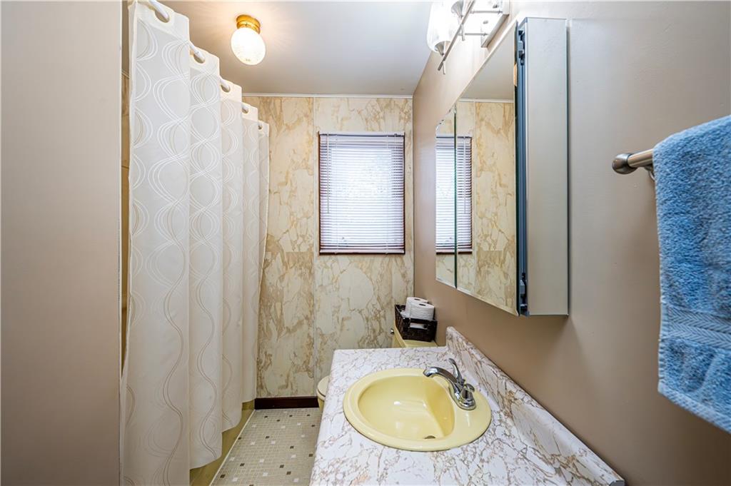 361 Middletown Road New Stanton, PA 15672 - Photo 26 of 43 a bathroom with a granite countertop sink and a mirror