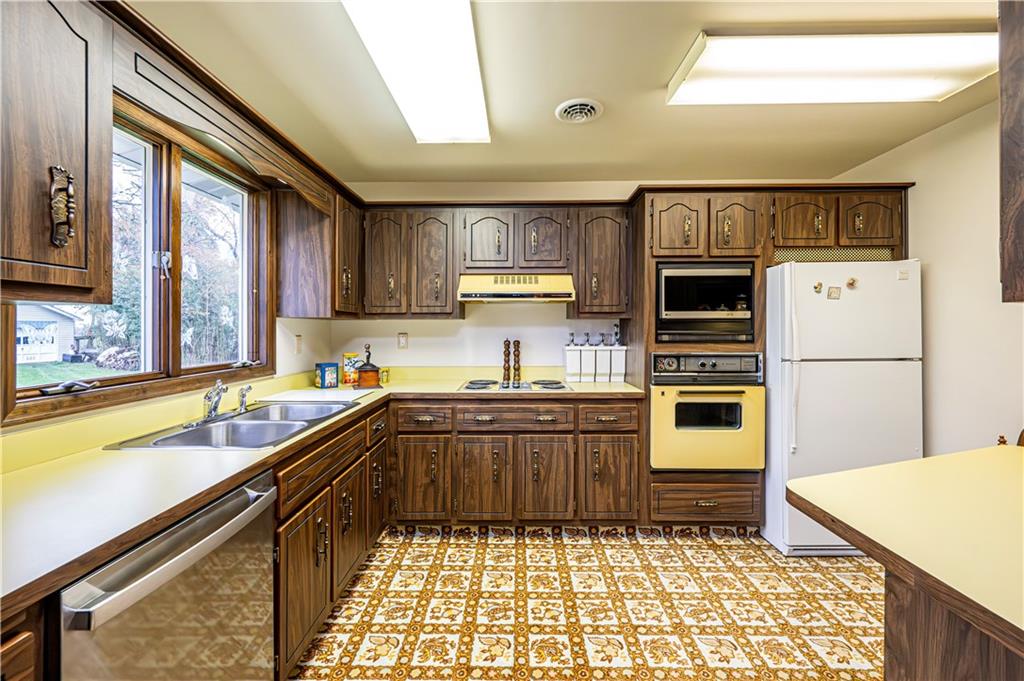 361 Middletown Road New Stanton, PA 15672 - Photo 32 of 43 a kitchen with stainless steel appliances granite countertop a sink stove and refrigerator
