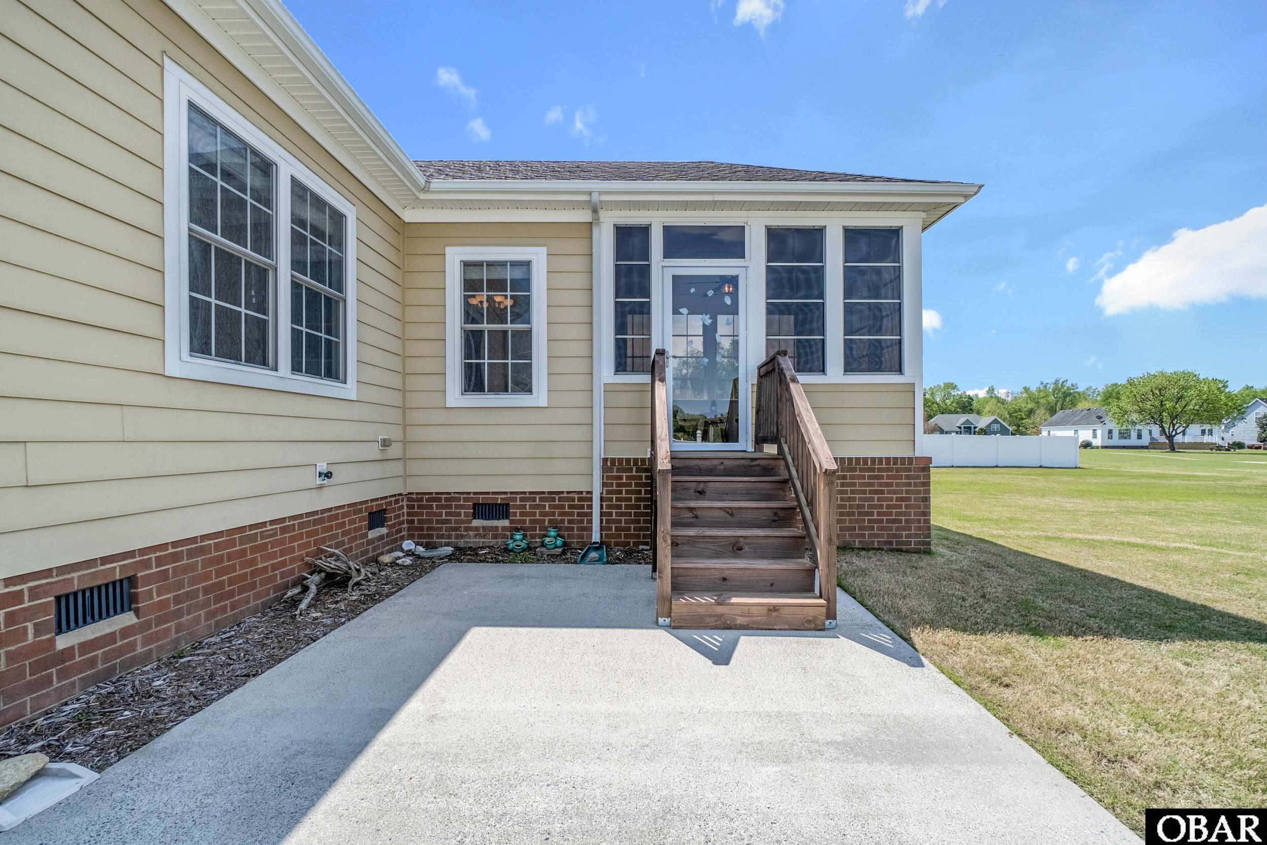 122 Bayside Drive Moyock, NC 27958 - Photo 29 of 34 Side of House With Large Concrete Driveway & Pad