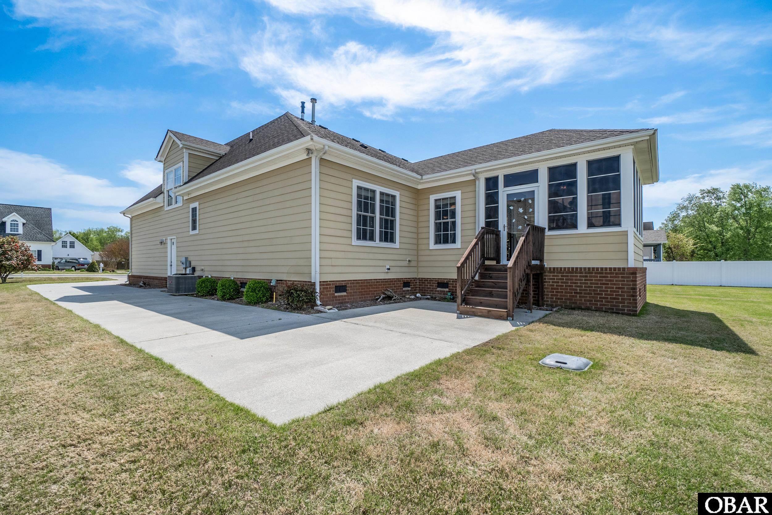 122 Bayside Drive Moyock, NC 27958 - Photo 30 of 34 Side of House with Large Conrete Driveway & Pad