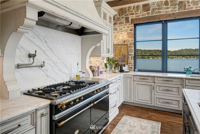 a white stove top oven sitting inside of a kitchen