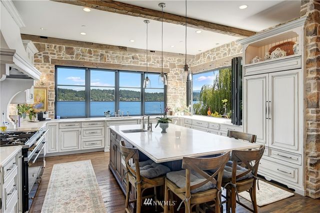 a kitchen with a table chairs stove and cabinets