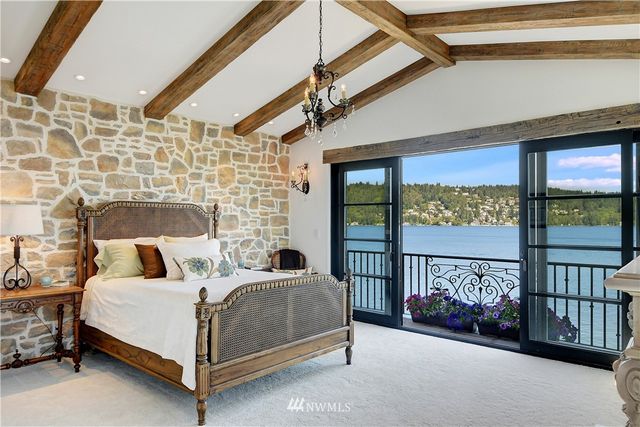 a bedroom with a bed and a large window