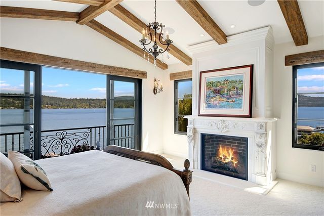 a bedroom with a bed and a fireplace