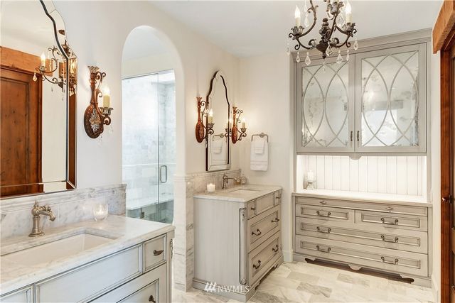 a bathroom with a double vanity sink mirror and