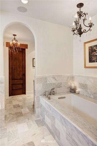 a bathroom with a tub sink and mirror