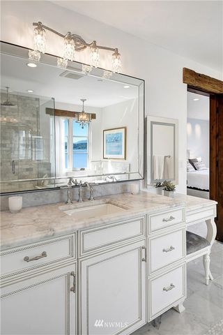 a bathroom with a sink vanity and mirror