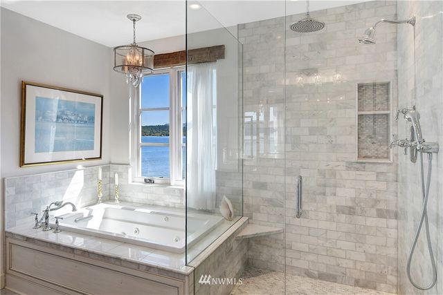 a bathroom with a granite countertop sink a mirror and shower