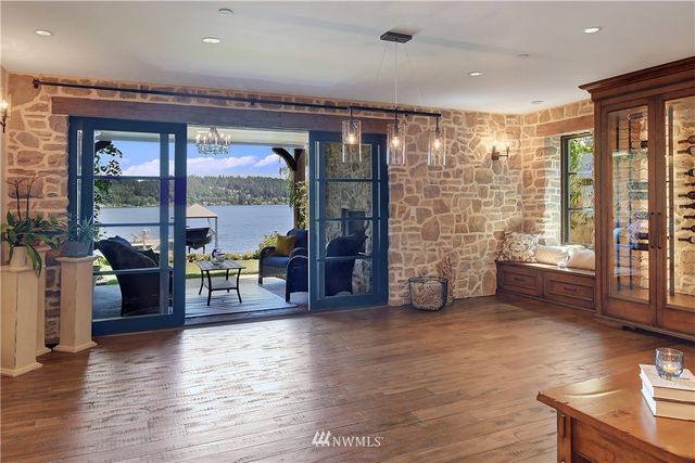 a living room with furniture and large windows