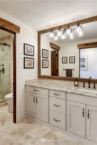 a spacious bathroom with a granite countertop sink and a mirror