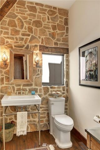 a bathroom with a toilet sink and mirror