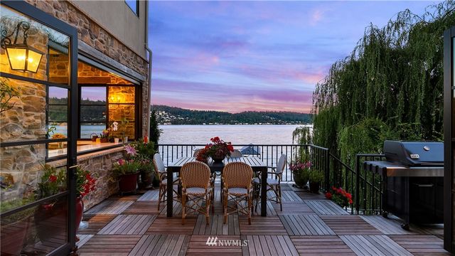a view of a balcony with wooden floor and outdoor seating