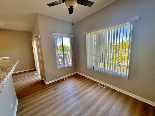 122 Enclave Circle, Unit D Bolingbrook, IL 60440 - Photo 10 of 20 an empty room with wooden floor and windows