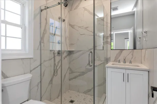 a bathroom with a shower and a sink