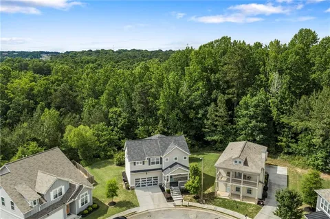 a view of a house with a backyard