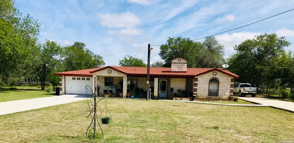 a front view of a house with a yard table and chairs