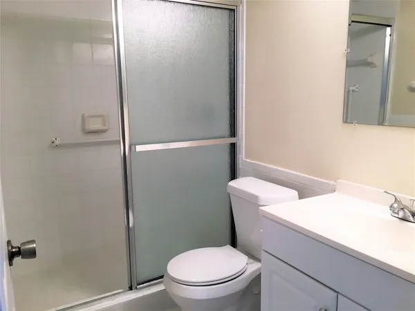 a white toilet sitting next to a bathroom sink