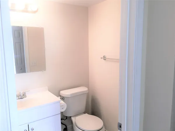 a white toilet sitting next to a bathroom sink