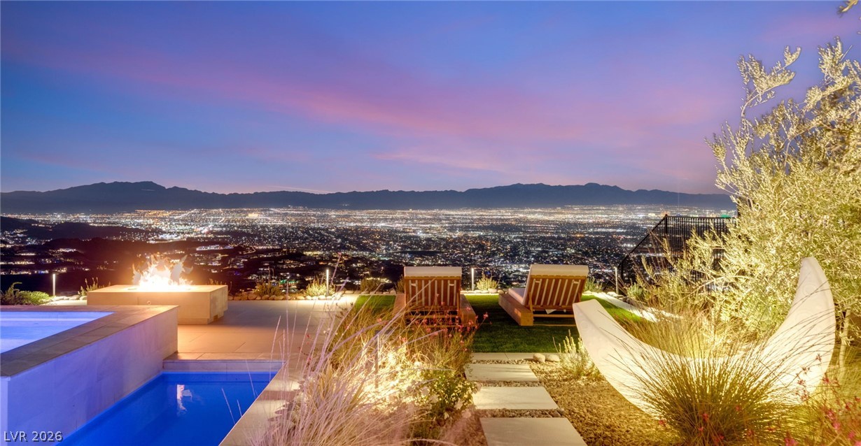 571 Overlook Rim Drive Henderson, NV 89012 - Photo 68 of 85 Pool at dusk with a mountain view, a patio, and a fire pit