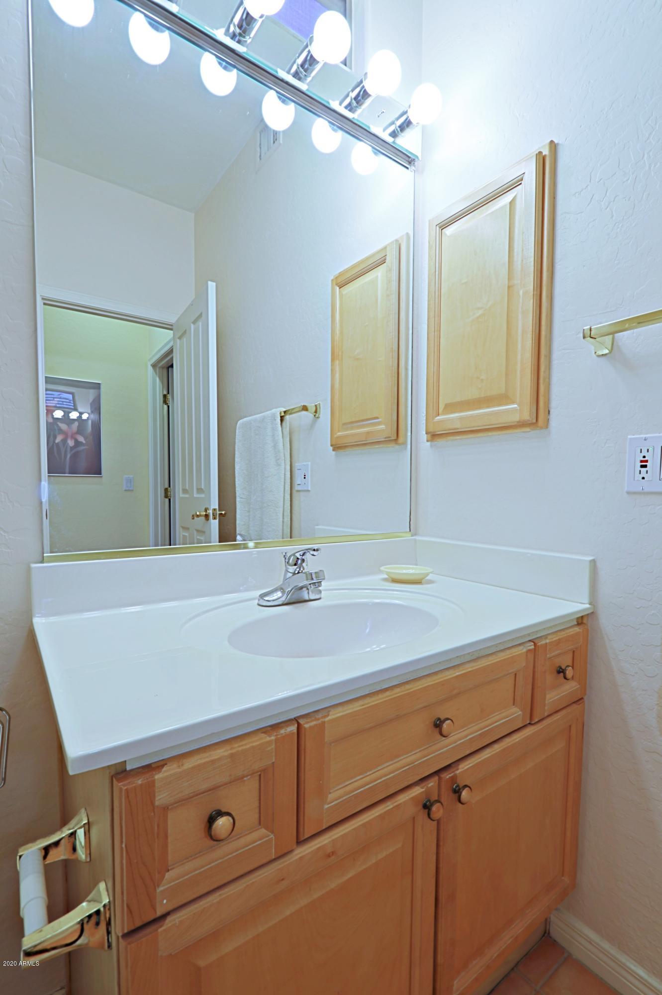 6803 East Eagle Feather Road Scottsdale, AZ 85266 - Photo 20 of 67 a bathroom with a sink and a mirror