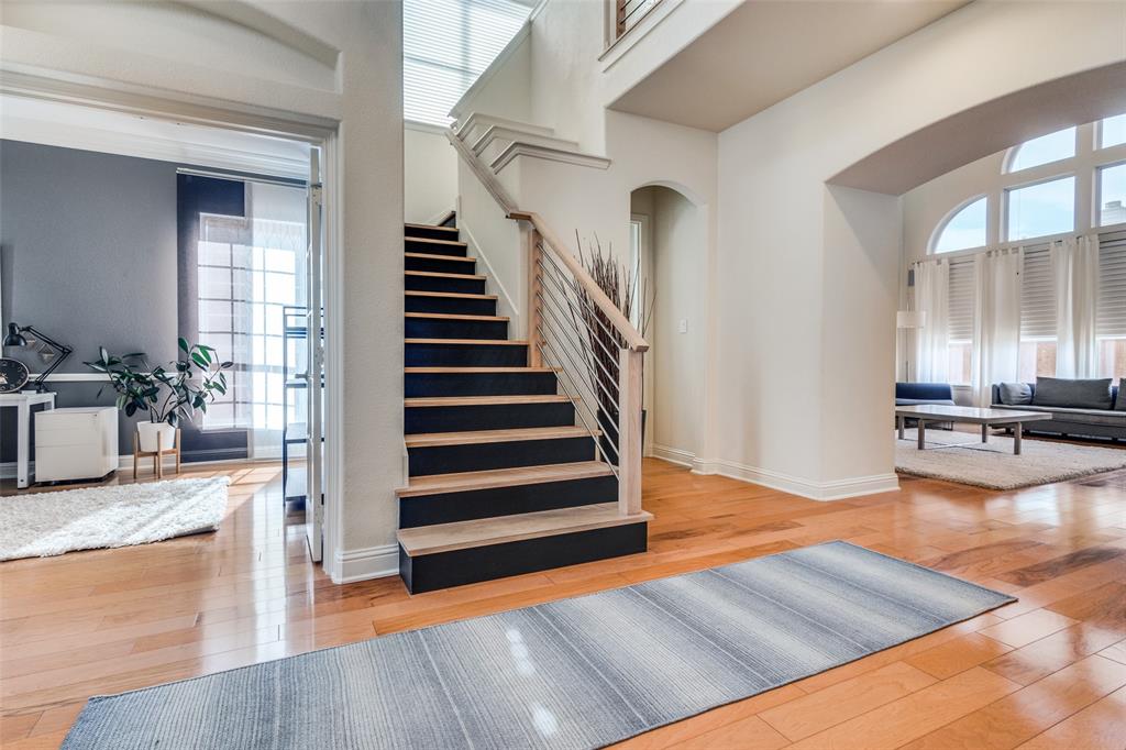 3313 Madison Avenue Hurst, TX 76054 - Photo 13 of 36 Stairs with a towering ceiling and wood flooring