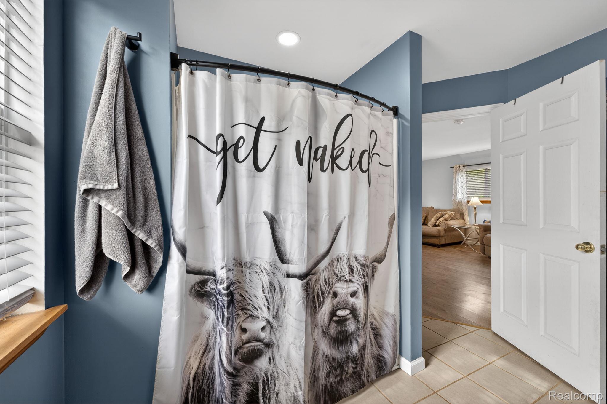 6354 Lapeer Road Burton, MI 48509 - Photo 18 of 44 Bathroom featuring a shower with shower curtain and tile patterned floors