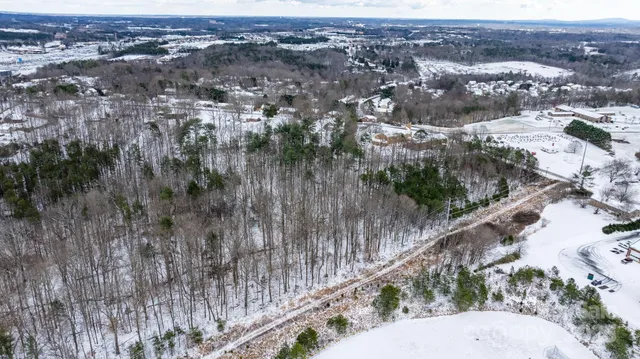 an aerial view of a house with a yard and lake view
