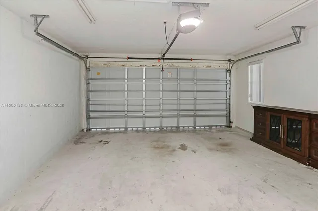 a very nice looking room with a large window and chandelier