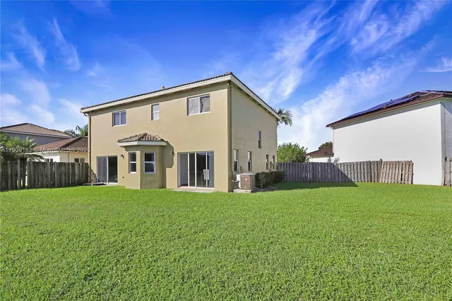 a view of a lake with houses in the back