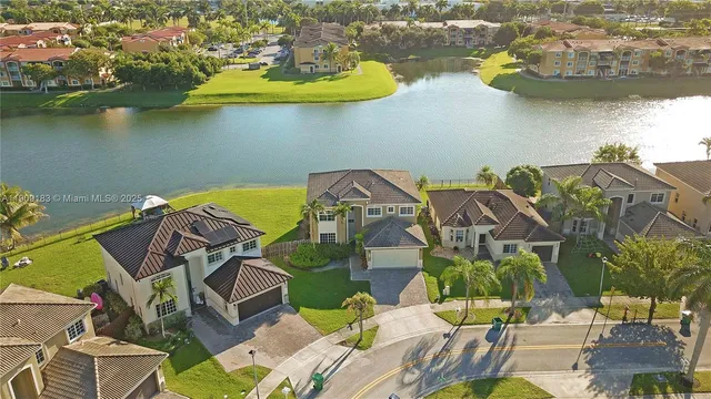 an aerial view of a house with a lake view