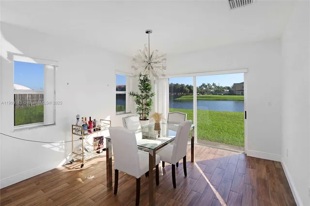 a view of a dining room with furniture window and wooden floor