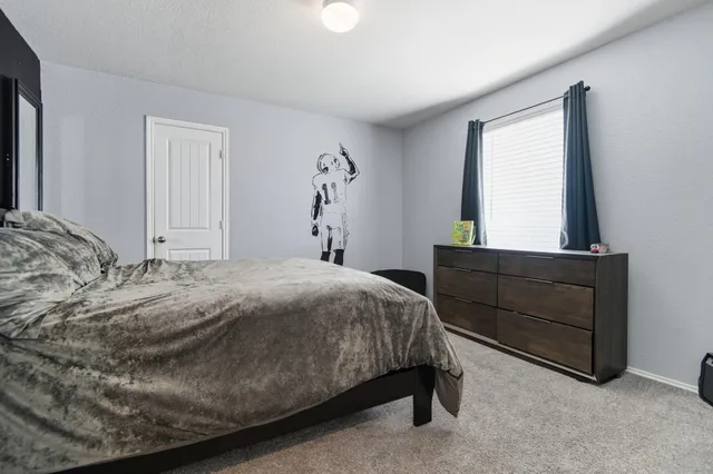 a bedroom with a bed and window