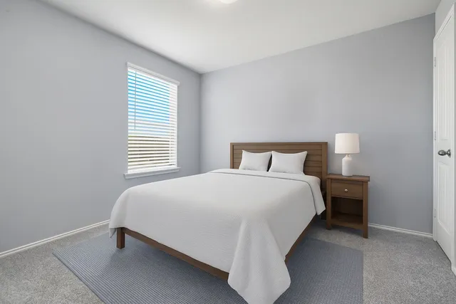 a bedroom with a bed and window