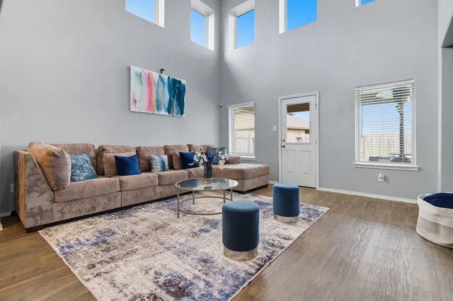 a living room with furniture and wooden floor