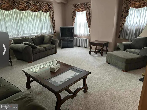 a living room with furniture and a rug